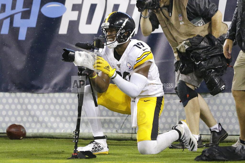 James Kenney Pittsburgh Steelers wide receiver JuJu Smith-Schuster jokes with a photographer's camera after catching a 17-yard touchdown pass against the Tennessee Titans in the first half of a preseason NFL football game Sunday, Aug. 25, 2019, in Nashville, Tenn. (AP Photo/James Kenney)