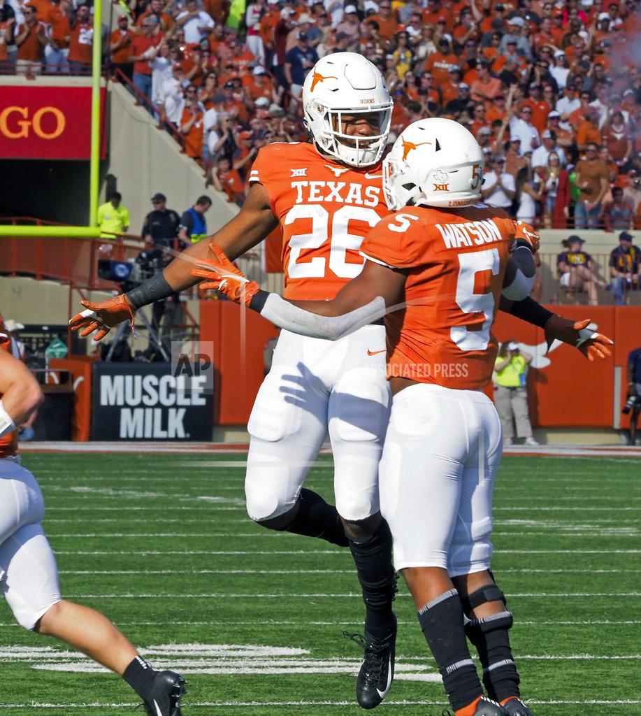 Michael Thomas Texas' Tre Watson (5) celebrates his touchdown run with Texas' Keaontay Ingram (26) during the first half of an NCAA college football game against West Virginia, Saturday, Nov. 3, 2018, in Austin, Texas. (AP Photo/Michael Thomas)