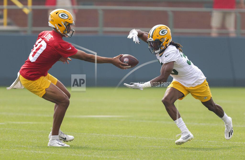 Matt Ludtke Green Bay Packers' quarterback Jordan Love (10) hands the ball off to Green Bay Packers' running back Aaron Jones (33) during NFL football training camp Saturday, July 31, 2021, in Green Bay, Wis. (AP Photo/Matt Ludtke)