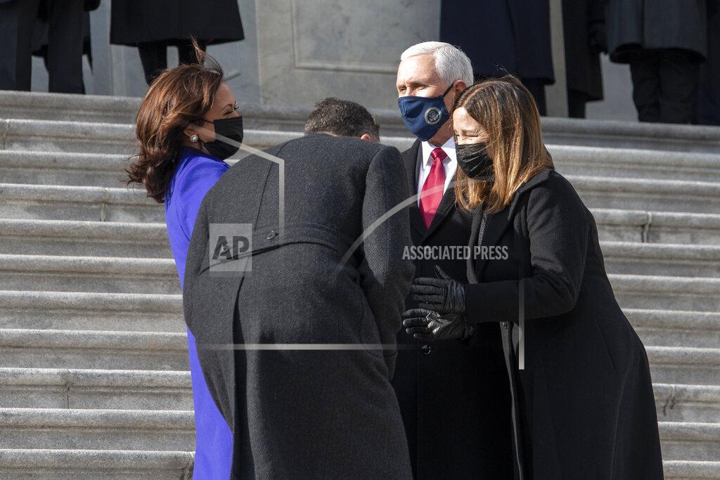 Rod Lamkey Vice President Kamala Harris and her husband Doug Emhoff, chat with former Vice President Mike Pence and his wife Karen as they walk down the Capitol steps following the inauguration of President Joe Biden, Wednesday, Jan. 20, 2021, at the U.S. Capitol in Washington. (Rod Lamkey/Pool Photo via AP)
