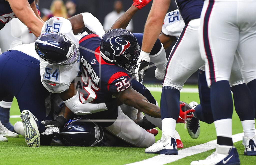 Eric Christian Smith Houston Texans running back Duke Johnson (25) reaches the ball across the goal line to score a touchdown as Tennessee Titans inside linebacker Rashaan Evans (54) defends during the first half of an NFL football game Sunday, Dec. 29, 2019, in Houston. (AP Photo/Eric Christian Smith)