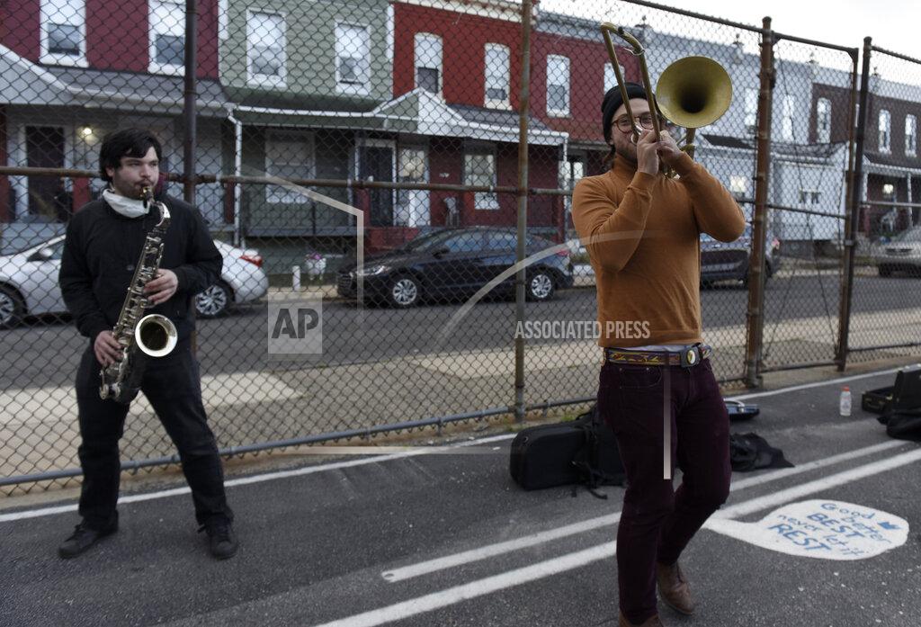 Michael Perez Josh Holcolm, right, plays his trombone in the parking lot of the Global Leadership Academy which is a polling site in West Philadelphia. Election Day, Tuesday, Nov. 3, 2020, in Philadelphia. (AP Photo/Michael Perez)