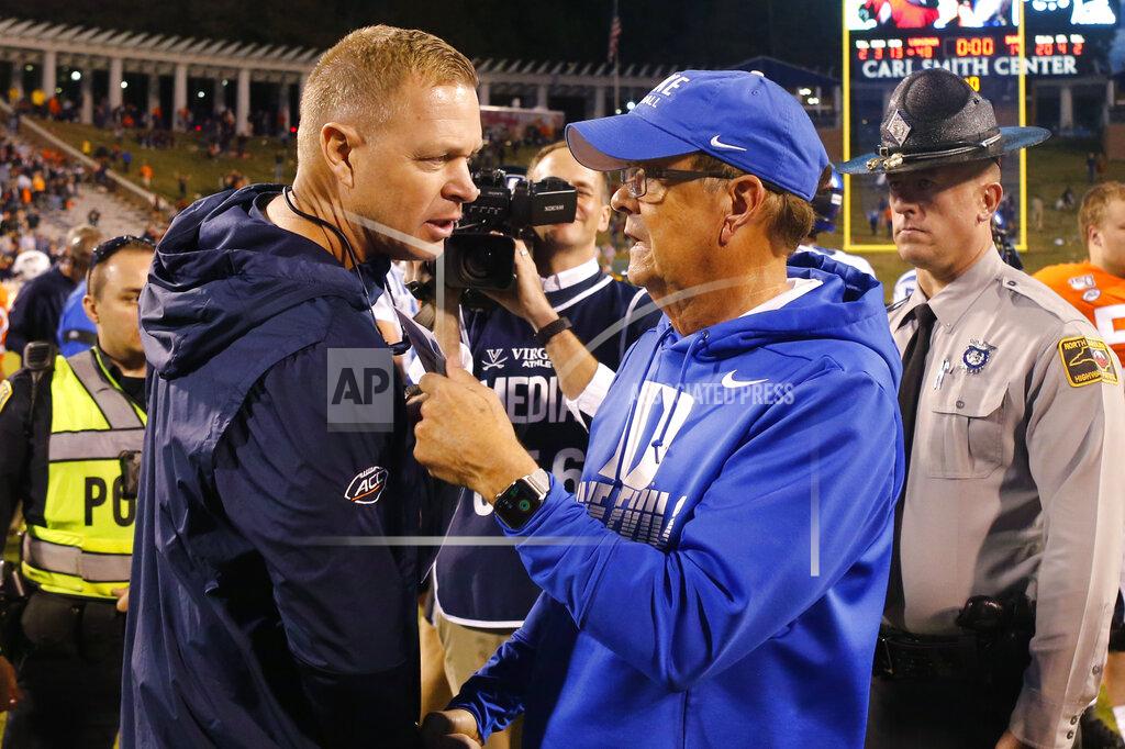 Steve Helber FILE - In this Oct. 19, 2019, file photo, Virginia head coach Bronco Mendenhall, left, talks with Duke head coach David Cutcliffe after an NCAA college football game in Charlottesville, Va. Virginia is finally set to open its season after three prior scheduled openers were scrapped because of the coronavirus pandemic. It’s only the second time in David Cutcliffe’s 13 years at Duke that the Blue Devils have lost their first two games. (AP Photo/Steve Helber, File)