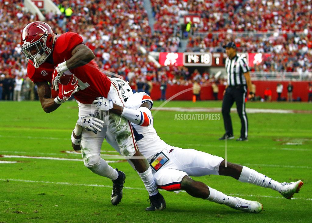 Butch Dill Alabama wide receiver Henry Ruggs III, left, drags Auburn defensive back Smoke Monday into the end zone for a touchdown during the first half of an NCAA college football game, Saturday, Nov. 24, 2018, in Tuscaloosa, Ala. (AP Photo/Butch Dill)