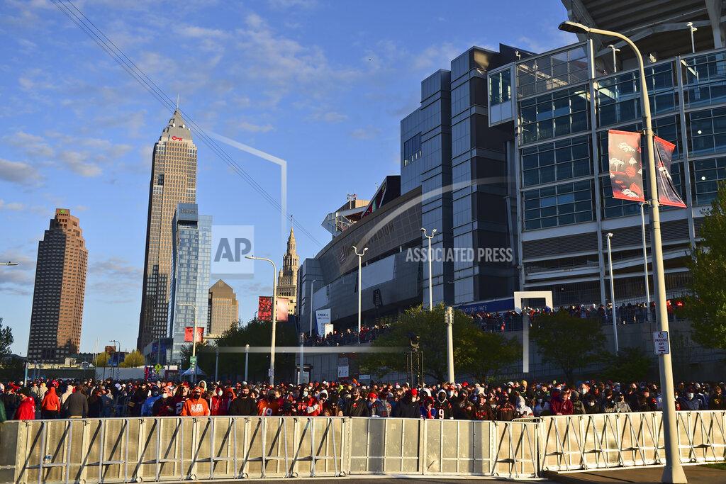 David Dermer Football fans watch from outside the NFL Draft Theatre during the second round of the NFL football draft, Friday, April 30, 2021, in Cleveland. (AP Photo/David Dermer)