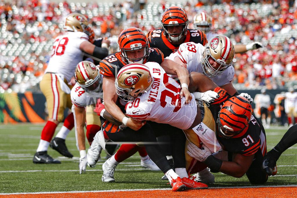 Frank Victores San Francisco 49ers running back Jeffrey Wilson (30) scores a touchdown against Cincinnati Bengals outside linebacker Nick Vigil (59) during the second half an NFL football game, Sunday, Sept. 15, 2019, in Cincinnati. (AP Photo/Frank Victores)
