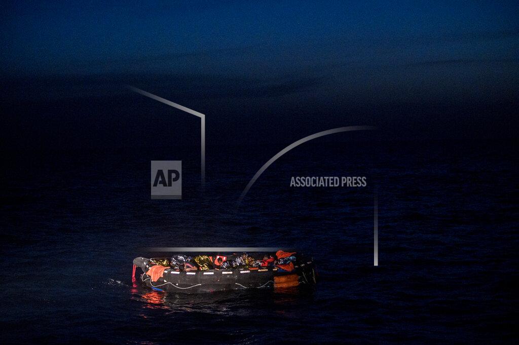 Valeria Ferrario Migrants sit in a life raft off the waters of Tunisia early Wednesday, May 25, 2022. Some 110 people were rescued by the non-governmental organization Open Arms during a mission in the Mediterranean Sea after their boat capsized. (AP Photo/Valeria Ferraro)