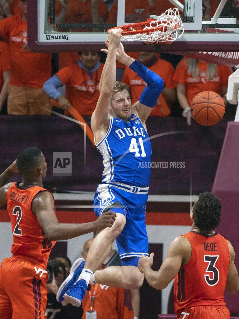 Don Peteresen Duke forward Jack White (41) dunks between Virginia Tech guards Wabissa Bede (3) and Landers Nolley II (2) during the second half of an NCAA college basketball game Friday, Dec. 6, 2019, in Blacksburg, Va. (AP Photo/Don Petersen)