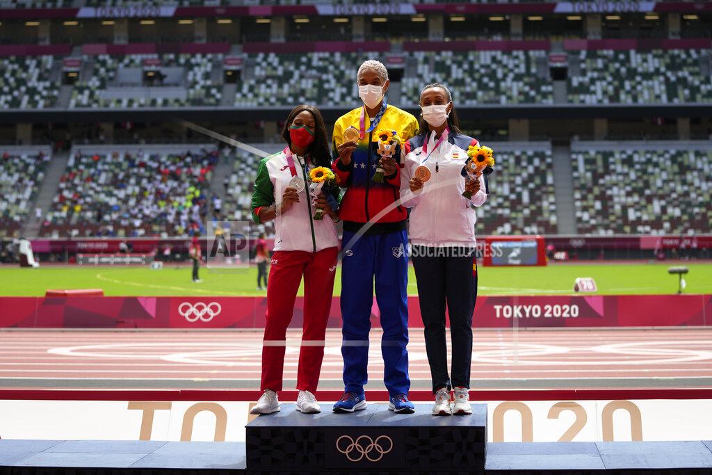 Francisco Seco Gold medalist, Yulimar Rojas, centre, of Venezuela, stands with silver medalist Patricia Mamona, left, of Portugal, and bronze medalist Ana Peleteiro, of Spain, following the women's triple jump at the 2020 Summer Olympics, Monday, Aug. 2, 2021, in Tokyo. (AP Photo/Francisco Seco)