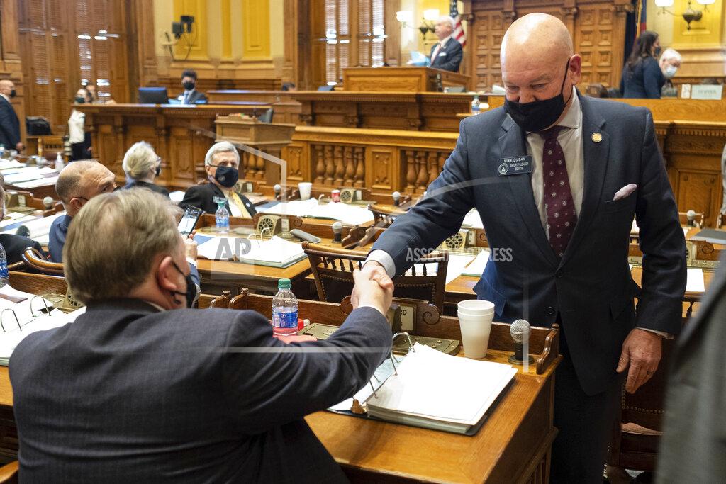 Ben Gray Georgia State Sen. Mike Dugan (R-Carrollton) shakes hands with Rules Committee Chairman Sen. Jeff Mullis (R-Chickamauga) after the passage of Senate Bill 241, which changes Georgia's voting laws, Monday, March 8, 2021, at the State Capitol in Atlanta. Dugan presented the bill. (AP Photo/Ben Gray)