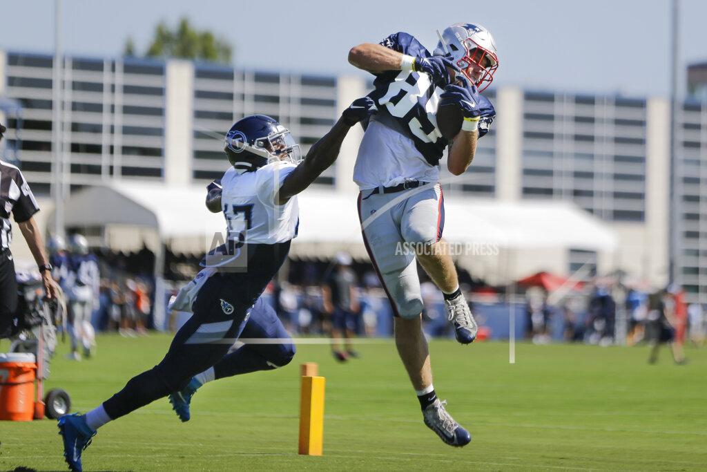 Mark Humphrey New England Patriots tight end Ryan Izzo (85) catches a pass as he is defended by Tennessee Titans defensive back JoJo Tillery (47) during a combined NFL football training camp Thursday, Aug. 15, 2019, in Nashville, Tenn. (AP Photo/Mark Humphrey)