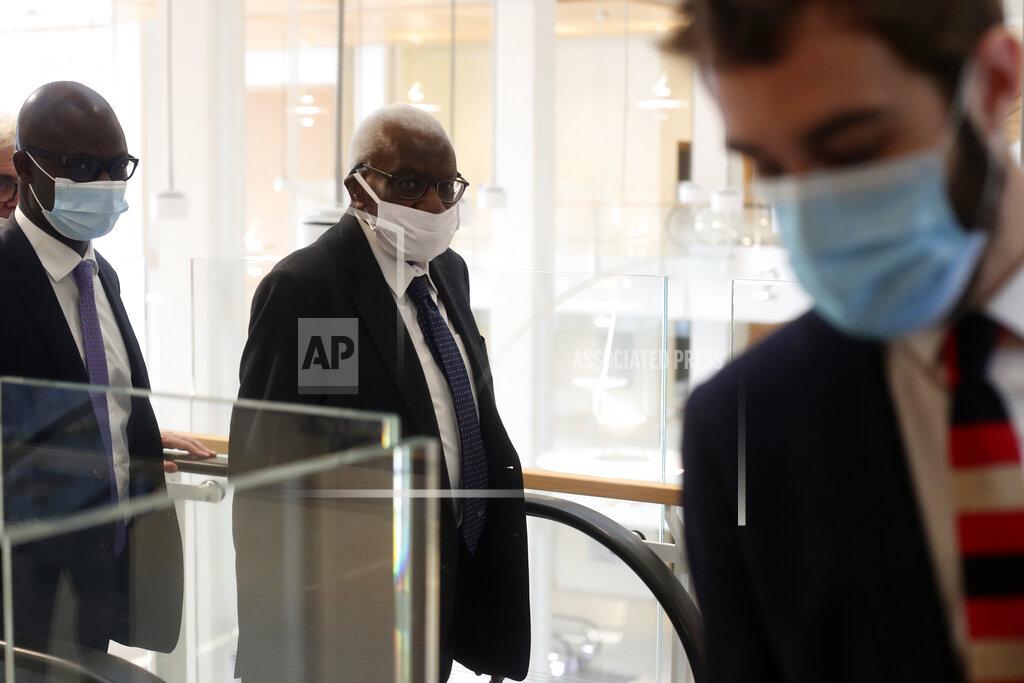 Thibault Camus Former president of the IAAF (International Association of Athletics Federations) Lamine Diack, center, arrives at the Paris courthouse, Monday, June 8, 2020. A sweeping sports corruption trial opened Monday in Paris involving allegations of a massive doping cover-up that reached to the top of world track and field's governing body. Lamine Diack, 87, who served as president of the body for nearly 16 years, is among those accused of receiving money from Russian athletes to hide their suspected doping so they could compete at the Olympics in 2012 and other competitions. His son Papa Massata Diack is also charged in the case. (AP Photo/Thibault Camus)