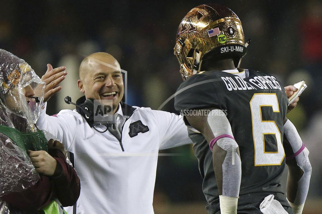 Stacy Bengs FILE - In this Oct. 26, 2018, file photo, Minnesota head coach P.J. Fleck greets wide receiver Tyler Johnson after the team scored against Indiana during an NCAA college football game, in Minneapolis. Minnesota has extended football coach P.J. Fleck's contract again by one year, through the 2023 season. The university announced the agreement on Friday, Dec. 14, 2018, after it was approved by the Board of Regents. (AP Photo/Stacy Bengs, File)