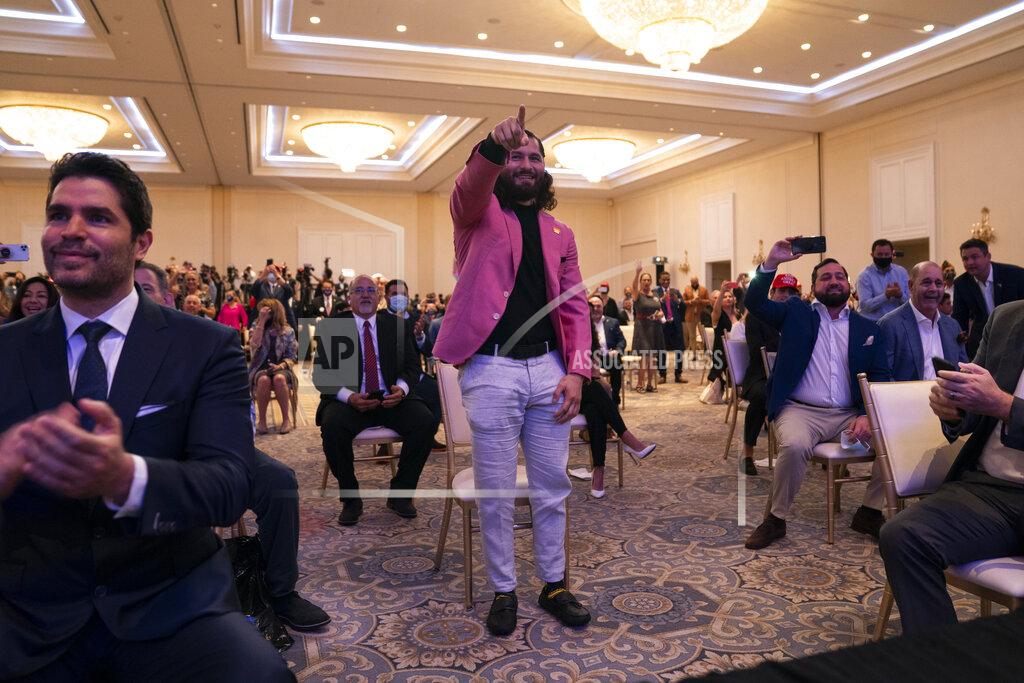 Evan Vucci UFC fighter Jorge Masvidal points at President Donald Trump during a Latinos for Trump event at Trump National Doral Miami resort, Friday, Sept. 25, 2020, in Doral, Fla. (AP Photo/Evan Vucci)