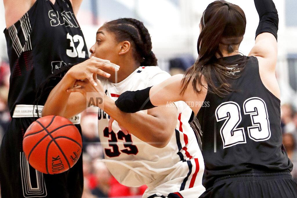 Keith Srakocic St. Francis (Pa)'s Jessica Kovatch (23) knocks the ball from Robert Morris' Nneka Ezeigbo (33) who was driving to the hoop during the first half of an NCAA college basketball game for the championship of the Northeast Conference women's tournament, Sunday, March 17, 2019, in Moon, Pa. (AP Photo/Keith Srakocic)