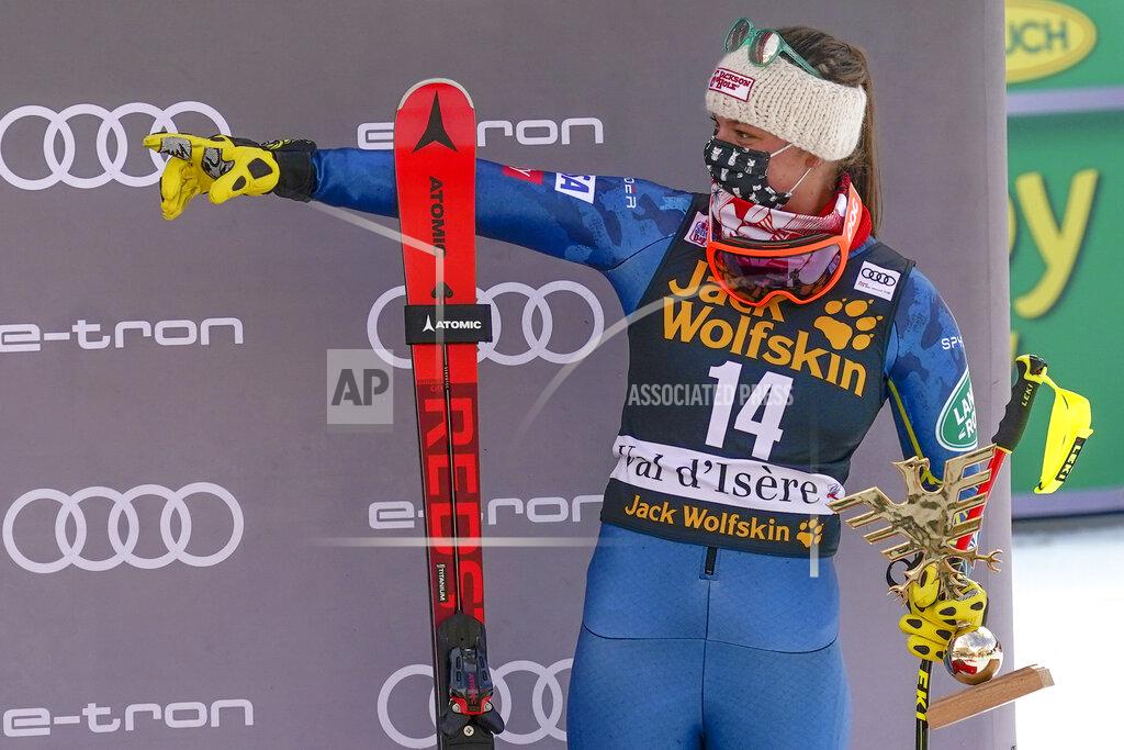 United States' Breezy Johnson holds the trophy after finishing third in a alpine ski, women's World Cup downhill, in Val d'Isere, France, Saturday, Dec.19, 2020. (AP Photo/Giovanni Auletta)