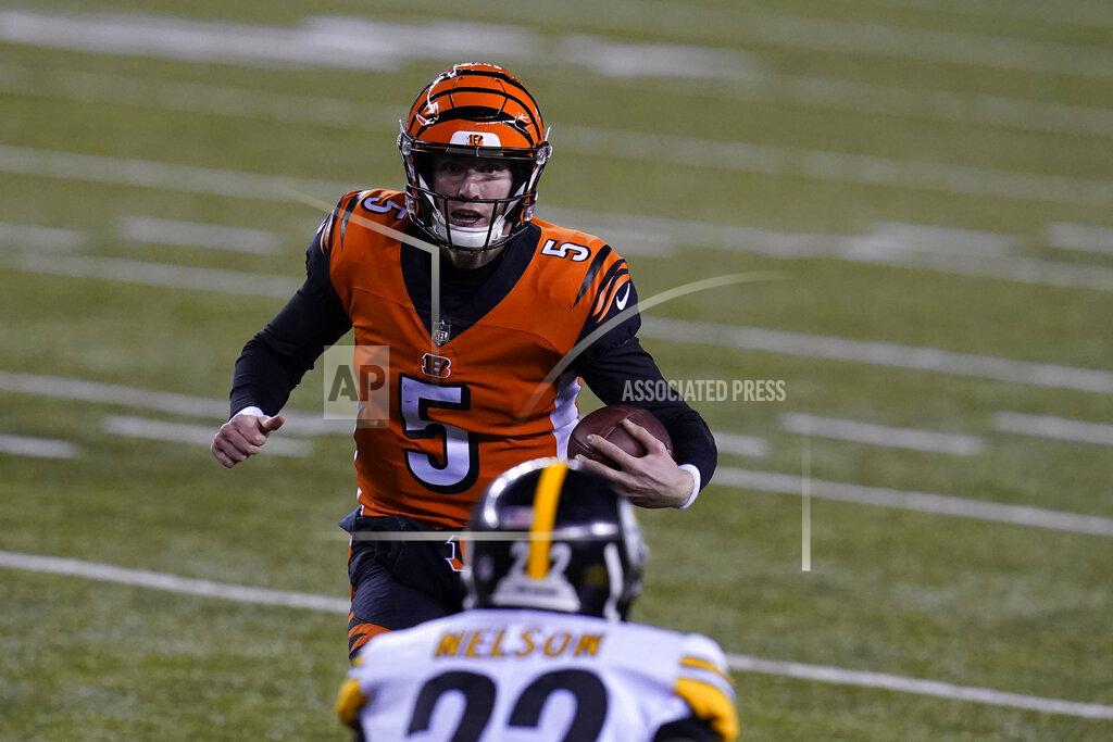 Michael Conroy Cincinnati Bengals quarterback Ryan Finley (5) runs against Pittsburgh Steelers' Steven Nelson (22) during the first half of an NFL football game, Monday, Dec. 21, 2020, in Cincinnati. (AP Photo/Michael Conroy)
