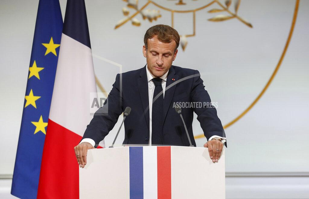 Gonzalo Fuentes French President Emmanuel Macron pauses as he delivers a speech during a meeting in memory of the Algerians who fought alongside French colonial forces in Algeria's war, known as Harkis, at the Elysee Palace in Paris, Monday, Sept. 20, 2021. Macron's speech is the latest step in his efforts to reconcile France with its dark colonial past, especially in Algeria. (Gonzalo Fuentes/Pool Photo via AP)