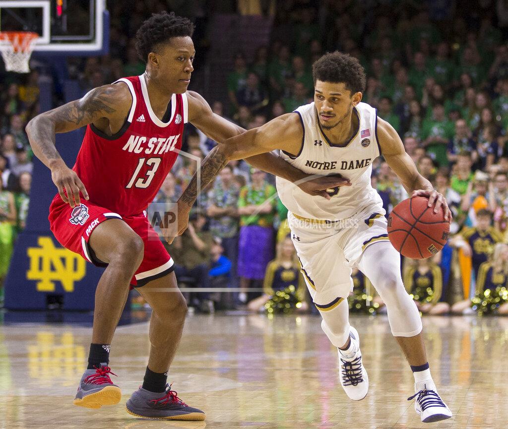 Robert Franklin Notre Dame's Prentiss Hubb, right, drives in with pressure from North Carolina State's C.J. Bryce (13) during the second half of an NCAA college basketball game Saturday, Jan. 19, 2019, in South Bend, Ind. North Carolina State won 77-73. (AP Photo/Robert Franklin)