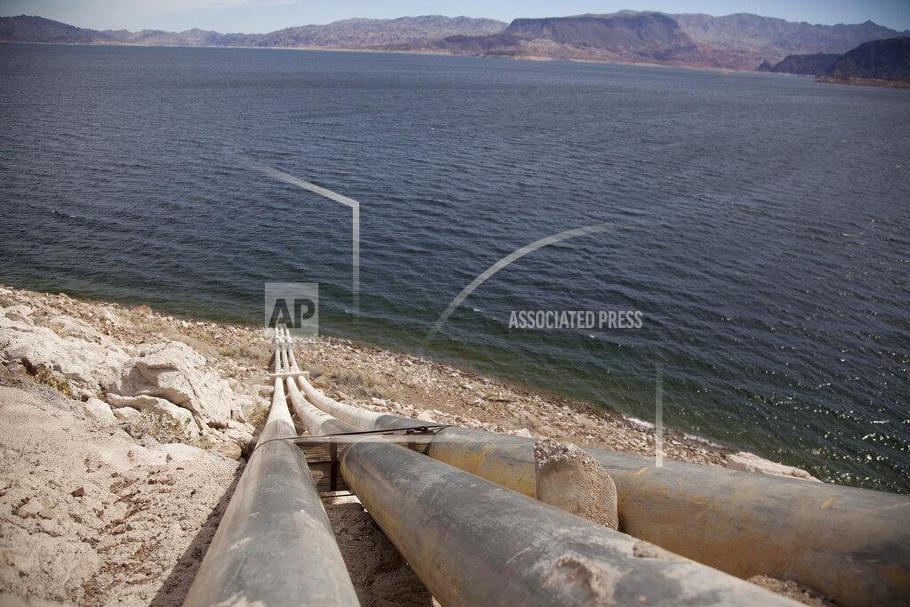 Julie Jacobson FILE - Pipes extend into Lake Mead well above the high water mark near Boulder City, Nev., on March 23, 2012. The sight of fountains, swimming pools, gardens and golf courses in Western cities like Phoenix, Los Angeles, Las Vegas, San Diego and Albuquerque can seem jarring with drought and climate change tightening their grip on the region. But Western water experts say they aren’t necessarily cause for concern. Many Western cities over the past three decades have diversified their water sources, boosted local supplies, and use water more efficiently now than in the past. (AP Photo/Julie Jacobson, File)