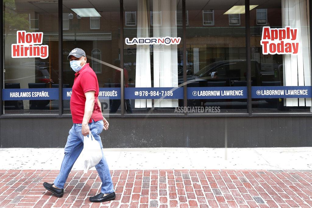 Elise Amendola A man walks by a career center storefront, Friday, June 5, 2020, in Lawrence, Mass. The U.S. unemployment rate fell unexpectedly in May to 13.3% — still on par with what the nation witnessed during the Great Depression — as states loosened their coronavirus lockdowns and businesses began recalling workers. (AP Photo/Elise Amendola)