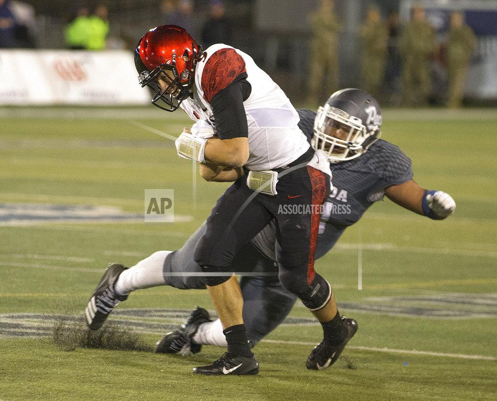 Tom R. Smedes San Diego State quarterback, right, is hit by Nevada's Dom Peterson (51) in the second half of an NCAA college football game in Reno, Nev., Saturday, Oct. 27, 2018. (AP Photo/Tom R. Smedes)