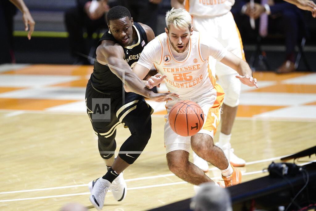 Calvin Mattheis Vanderbilt guard Maxwell Evans (3) and Tennessee's Santiago Vescovi (25) chase the ball during an NCAA college basketball game at Thompson-Boling Arena in Knoxville, Tenn., Saturday, Jan. 16, 2021. (Calvin Mattheis/Knoxville News Sentinel via AP, Pool)