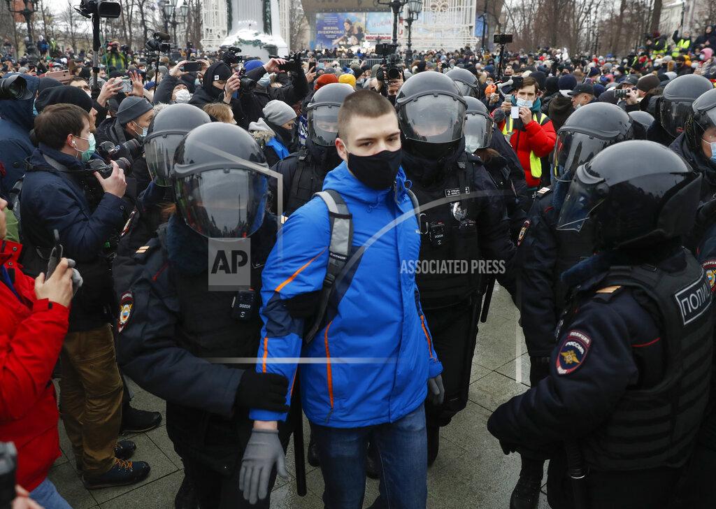 Pavel Golovkin Police detain a man during a protest against the jailing of opposition leader Alexei Navalny in Moscow, Russia, Saturday, Jan. 23, 2021. Russian police are arresting protesters demanding the release of top Russian opposition leader Alexei Navalny at demonstrations in the country's east and larger unsanctioned rallies are expected later Saturday in Moscow and other major cities. (AP Photo/Pavel Golovkin)
