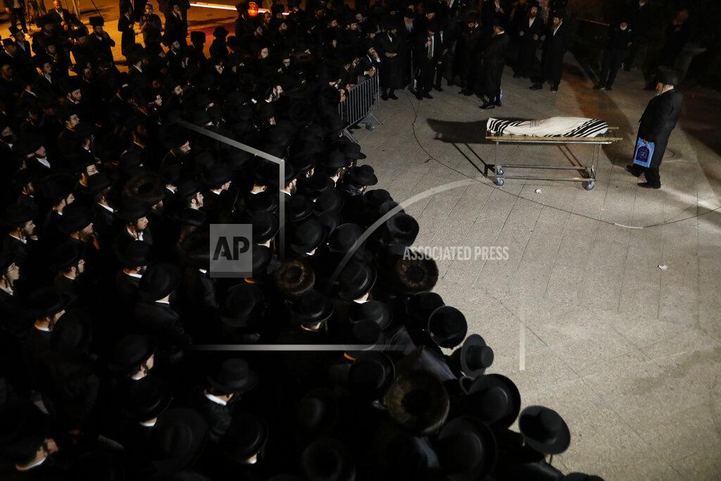 Ariel Schalit Mourners gather around the body of Menachem Knoblowitz, 21, from the United States, who died during Lag BaOmer celebrations at Mt. Meron in northern Israel, at his funeral in Jerusalem on Saturday, May 1 2021. A stampede at a religious festival attended by tens of thousands of ultra-Orthodox Jews in northern Israel killed dozens of people and injured about 150 early Friday, medical officials said. It was one of the country's deadliest civilian disasters. (AP Photo/Ariel Schalit)