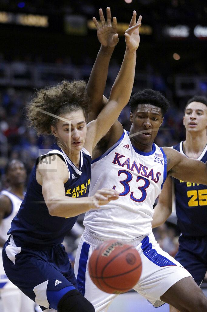 Orlin Wagner Kansas City forward Josiah Allick, left, and Kansas forward David McCormack (33) battle for a loose ball during the first half of an NCAA college basketball game in Kansas City, Kan., Saturday, Dec. 14, 2019. (AP Photo/Orlin Wagner)