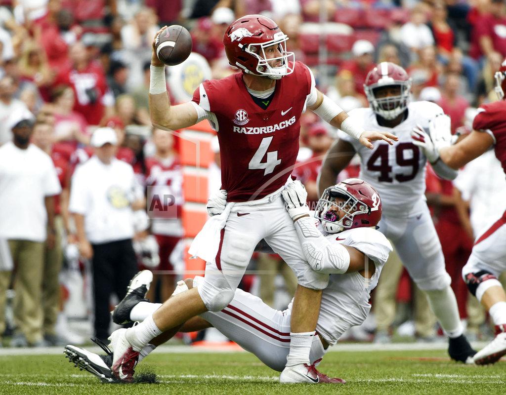 Michael Woods Alabama defender Christian Miller puts the pressure on Arkansas quarterback Ty Storey, top, as he throws a pass in the first half of an NCAA college football game Saturday, Oct. 6, 2018, in Fayetteville, Ark. (AP Photo/Michael Woods)