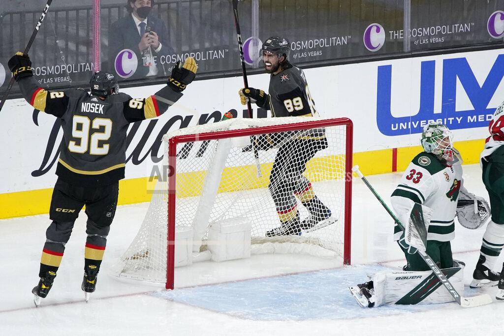 John Locher Vegas Golden Knights left wing Tomas Nosek (92) and right wing Alex Tuch (89) celebrate after defenseman Brayden McNabb (3), not pictured, scored against the Minnesota Wild during the third period of an NHL hockey game Thursday, April 1, 2021, in Las Vegas. (AP Photo/John Locher)