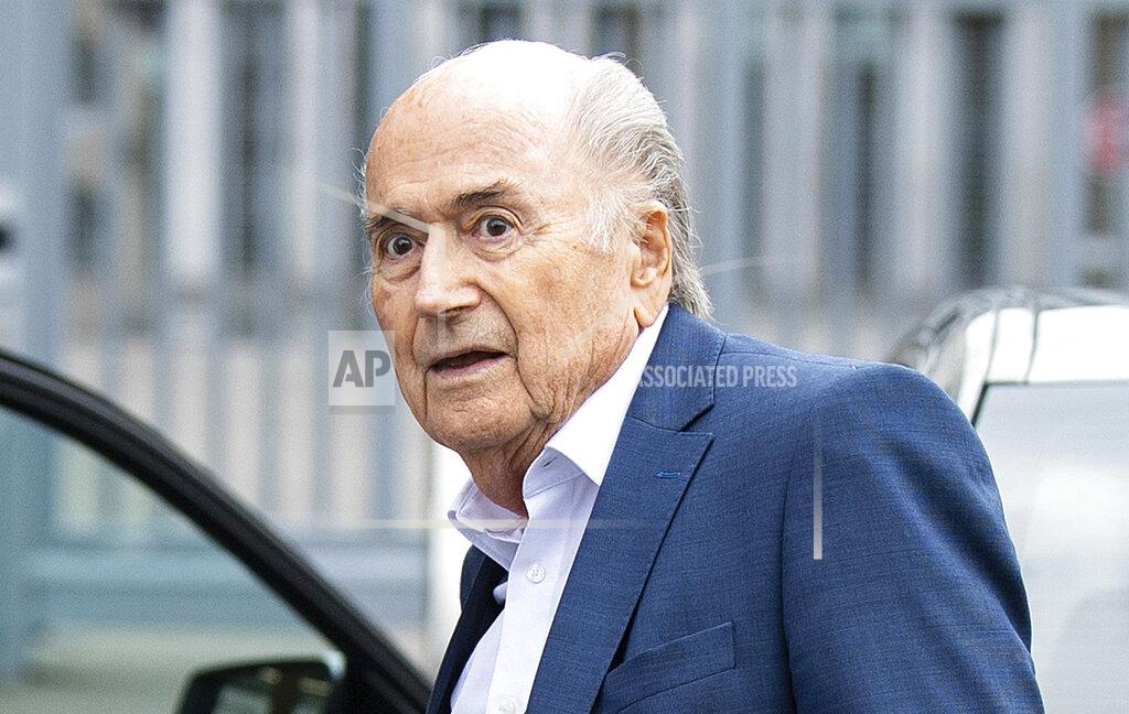 FILE - In this Tuesday, Sept. 1, 2020 file photo, former FIFA President Sepp Blatter, center, appears in front of the building of the Office of the Attorney General of Switzerland, in Bern, Switzerland. Former FIFA president Blatter spent a week in an induced coma after having heart surgery in December, his family said on Thursday, Jan. 21, 2021. The 84-year-old Blatter, who also tested positive for COVID-19 late last year, was well enough only this week to be moved from an intensive care unit at the hospital. (Peter Schneider/Keystone via AP, FIle)
