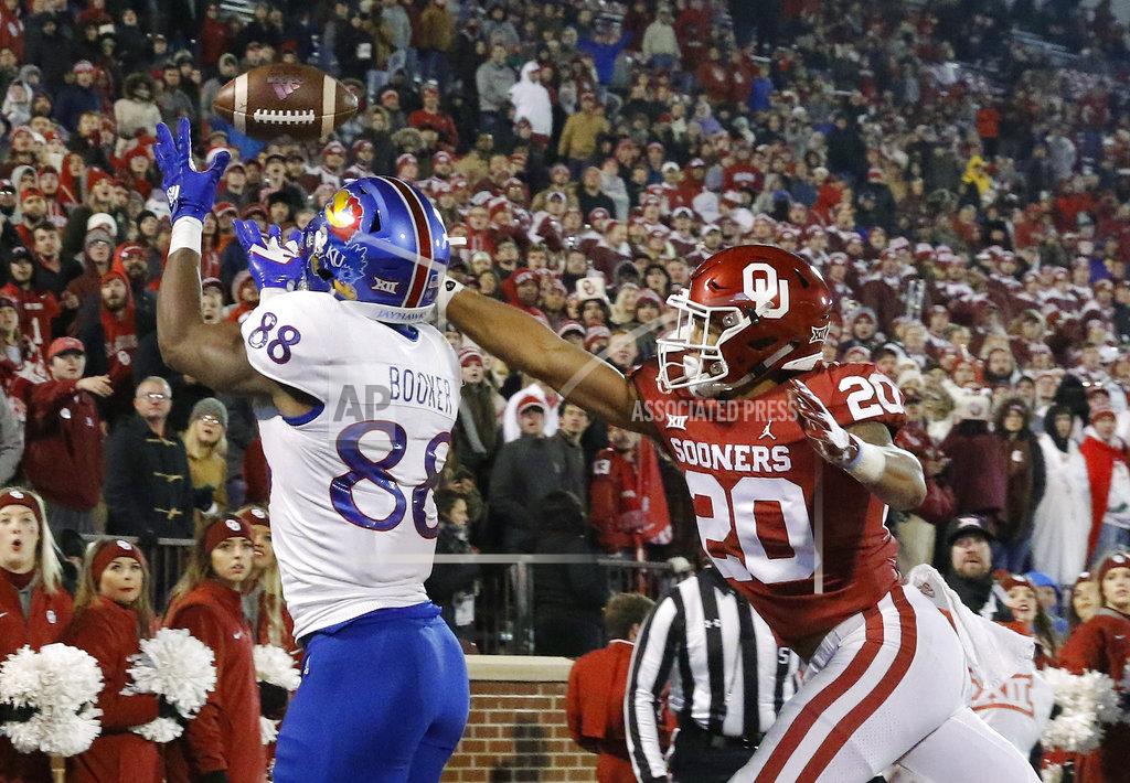Alonzo Adams Kansas wide receiver Jeremiah Booker (88) makes a catch for a touchdown ahead of Oklahoma safety Robert Barnes (20) during the second half of an NCAA college football game in Norman, Okla., Saturday, Nov. 17, 2018. Oklahoma won 55-40. (AP Photo/Alonzo Adams)
