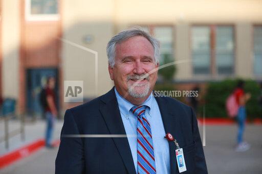 FILE - Albuquerque Public Schools superintendent Scott Elder poses for a photo outside of Highland High School on Aug. 11, 2021, in Albuquerque, N.M. Albuquerque Public Schools says classes will be canceled Friday, Jan. 14, 2022, for a second day after a cyber attack on the district's student database prompted a near-total shutdown of classes on Thursday, Jan. 13. (AP Photo/Cedar Attanasio, File)
