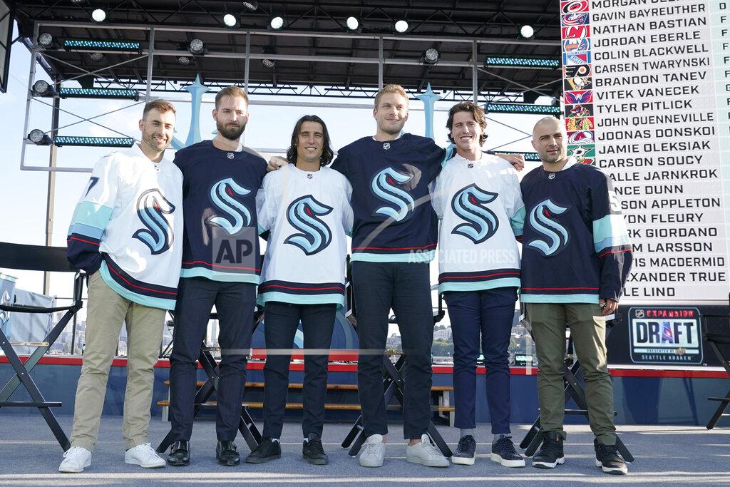 Ted S. Warren Seattle Kraken NHL hockey players Jordan Eberle, Chris Dreidger, Brandon Tanev, Jamie Oleksiak, Hadyn Fluery and Mark Giordano, from left, pose for a photo Wednesday, July 21, 2021, after being introduced during the Kraken's expansion draft event in Seattle. (AP Photo/Ted S. Warren)