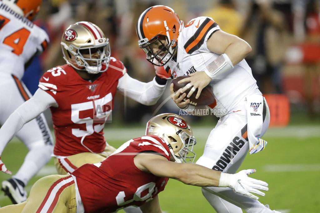 Ben Margot Cleveland Browns quarterback Baker Mayfield, top right, is sacked by San Francisco 49ers defensive end Nick Bosa, bottom, during the first half of an NFL football game in Santa Clara, Calif., Monday, Oct. 7, 2019. Also pictured is 49ers defensive end Dee Ford (55). (AP Photo/Ben Margot)