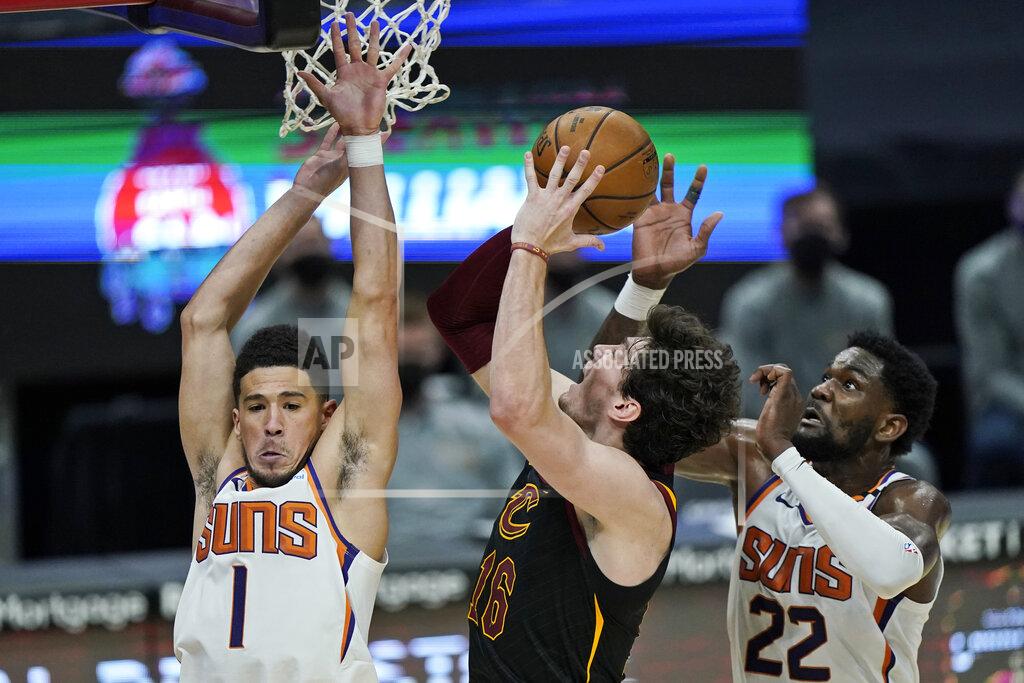 Tony Dejak Phoenix Suns' Devin Booker (1) and Deandre Ayton (22) defend against Cleveland Cavaliers' Cedi Osman (16) in the second half of an NBA basketball game, Tuesday, May 4, 2021, in Cleveland. Phoenix won 134-118 in overtime. (AP Photo/Tony Dejak)