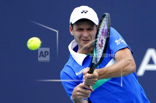 Lynne Sladky Hubert Hurkacz of Poland returns to Stefanos Tsitsipas of Greece during the quarterfinals of the Miami Open tennis tournament, Thursday, April 1, 2021, in Miami Gardens, Fla. Hurkacz won 2-6, 6-3, 6-4. (AP Photo/Lynne Sladky)