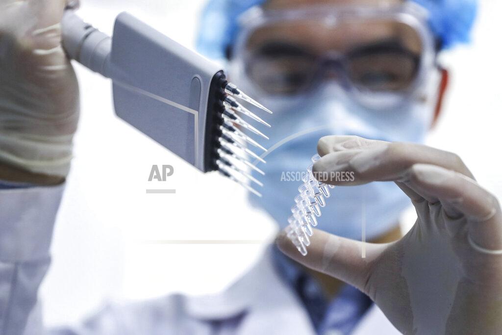 Zhang Yuwei In this April 11, 2020 photo, released by Xinhua News Agency, a staff member tests samples of a potential COVID-19 vaccine at a production plant of SinoPharm in Beijing. In the global race to make a coronavirus vaccine, the state-owned Chinese company is boasting that it gave its employees, including top executives, experimental shots even before the government OK'd testing in people. (Zhang Yuwei/Xinhua via AP)