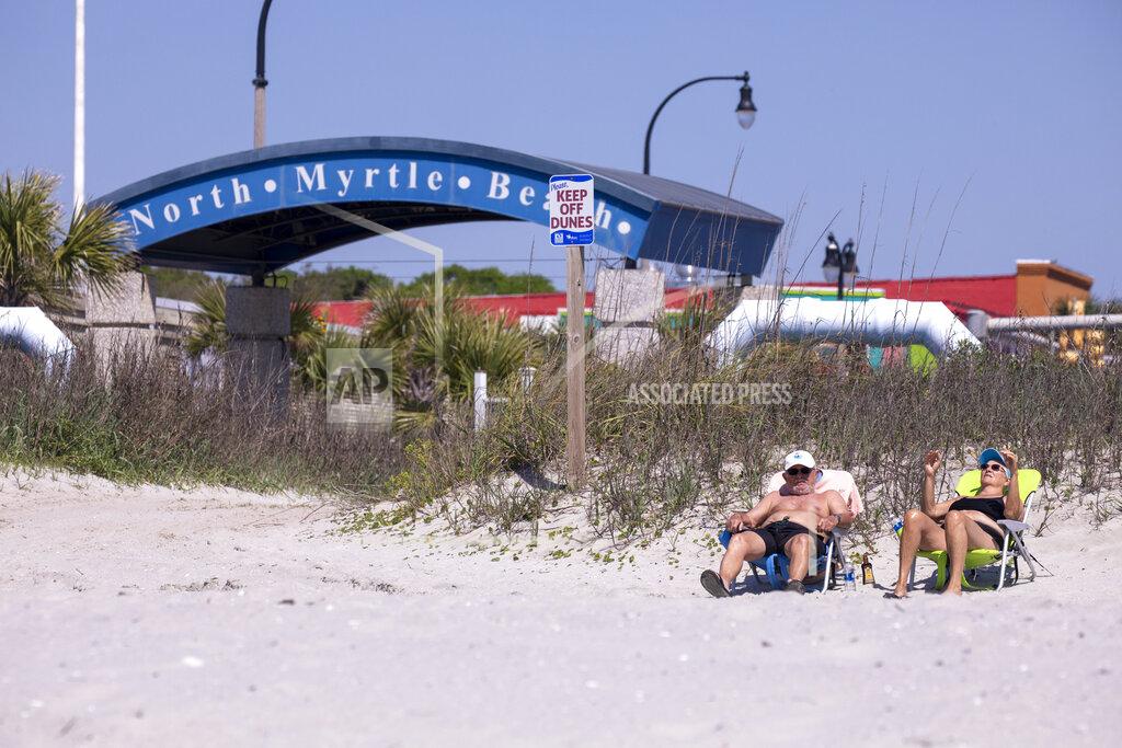 Tommy and Marilyn Loudermilk enjoy the beach in North Myrtle Beach on Tuesday. Governor Henry McMaster removed his close order, allowing local municipalities to make their own decisions as of noon on Tuesday. North Myrtle Beach, S.C. April 20, 2020. (Jason Lee/The Sun News via AP)