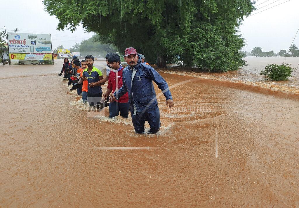 Uncredited National Disaster Response Force personnel rescue people stranded in floodwaters in Kolhapur, in the western Indian state of Maharashtra, Friday, July 23, 2021. Landslides triggered by heavy monsoon rains hit parts of western India, killing at least 32 people and leading to the overnight rescue of more than 1,000 other people trapped by floodwaters, officials said Friday. (AP Photo)