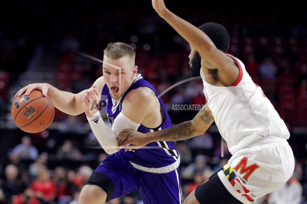 Julio Cortez Holy Cross guard Austin Butler, left, drives against Maryland guard Eric Ayala during the second half of an NCAA college basketball game, Tuesday, Nov. 5, 2019, in College Park, Md. Maryland won 95-71. (AP Photo/Julio Cortez)