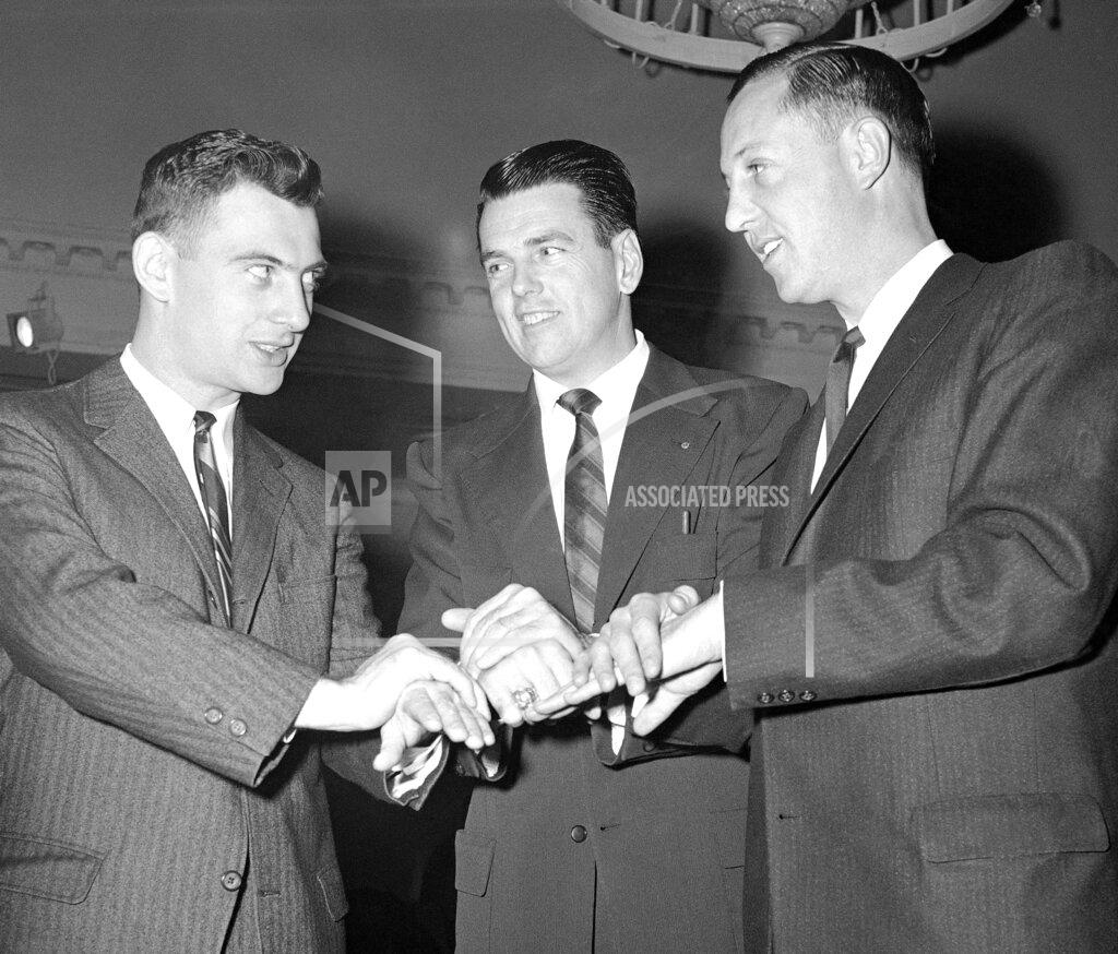 Sam Myers FILE - In this Dec. 1, 1958, file photo, from left, Dan Rooney, son of Pittsburgh Steelers owner Art Rooney, George Allen, assistant coach of the Chicago Bears and Pete Rozelle, general manager of the Los Angeles Rams, prepare to uncover coins determining picking order at the NFL Draft, in Philadelphia. The NFL draft has become an industry unto itself and the league's third-most popular annual event behind the Super Bowl and opening weekend. (AP Photo/Sam Myers, File)