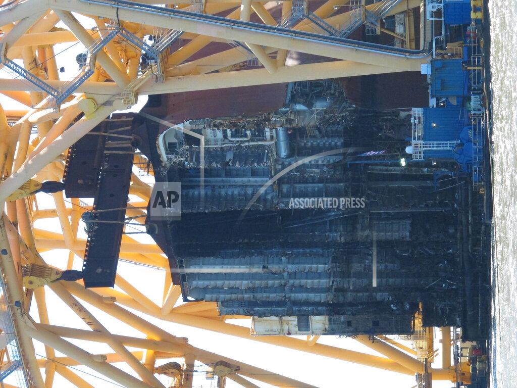 Russ Bynum A towering crane pulls the engine room section away from the remains of the capsized cargo ship Golden Ray on Monday, April 26, 2021, offshore of St. Simons Island, Ga. The South Korean vessel capsized with roughly 4,200 vehicles in its cargo decks in September 2019. The engine room section is the fourth giant chunk of the ship to be cut away and removed since demolition began in November 2020. (AP Photo/Russ Bynum)