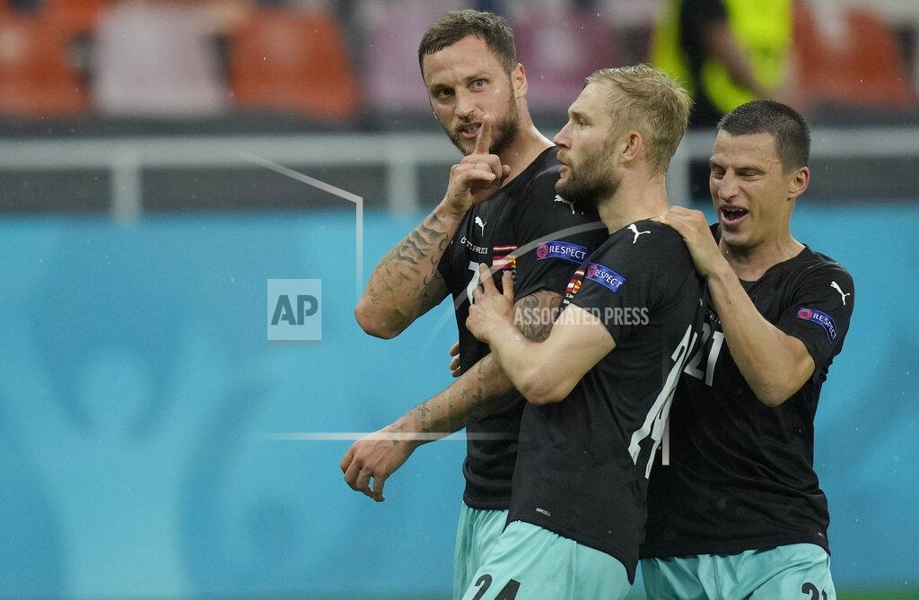 Vadim Ghirda Austria's Marko Arnautovic, left, celebrates with teammates after scoring his side's third goal during the Euro 2020 soccer championship group C match between Austria and Northern Macedonia at the National Arena stadium in Bucharest, Romania, Sunday, June 13, 2021. (AP Photo/Vadim Ghirda, Pool)