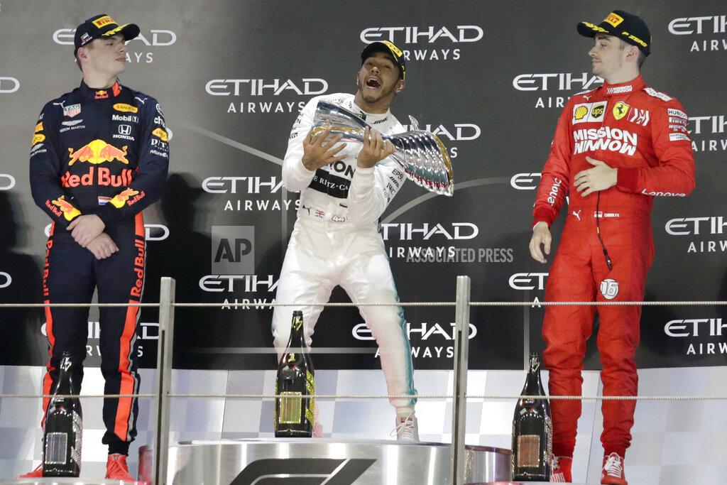 Hassan Ammar Mercedes driver Lewis Hamilton of Britain, center, celebrates on the podium with second placed Red Bull driver Max Verstappen of the Netherland's, left, and third placed Ferrari driver Charles Leclerc of Monaco after the Emirates Formula One Grand Prix at the Yas Marina racetrack in Abu Dhabi, United Arab Emirates, Sunday, Dec.1, 2019. (AP Photo/Hassan Ammar)