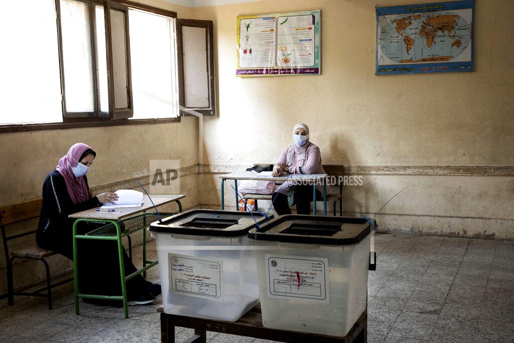 Nariman El-Mofty Election officials wait for people to vote on the first day of the Senate elections inside a polling station in Cairo, Egypt, Tuesday, Aug. 11, 2020. Egyptians started voting on Tuesday for the Senate, the upper chamber of parliament that was revived as part of constitutional amendments approved in a referendum last year — an election that comes as the country faces an uptick in daily numbers of new coronavirus cases. (AP Photo/Nariman El-Mofty)
