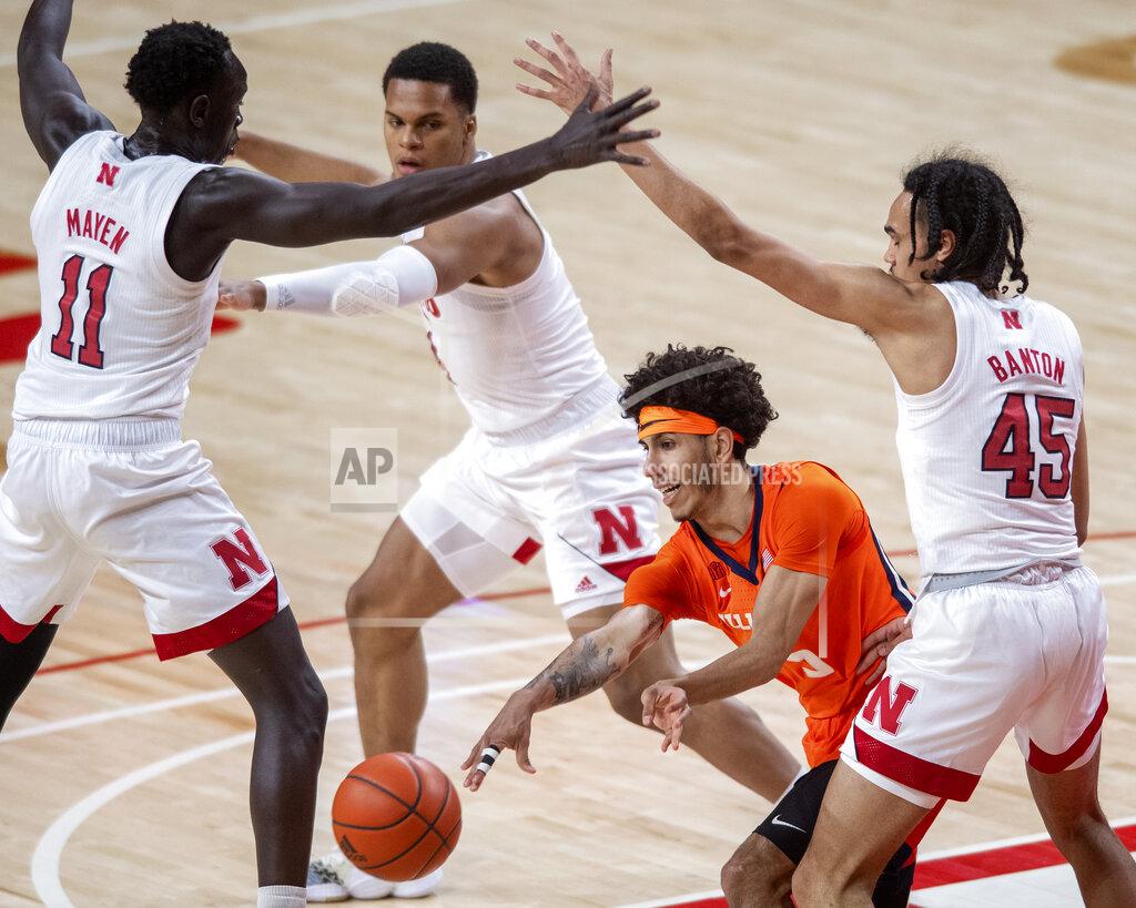 Francis Gardler Illinois' Andre Curbelo (5) passes to a teammate as he's defended by Nebraska's Dalano Banton (45), Shamiel Stevenson (4) and Lat Mayen (11) during the first half of an NCAA college basketball game Friday, Feb. 12, 2021, in Lincoln, Neb. (Francis Gardler/Lincoln Journal Star via AP)