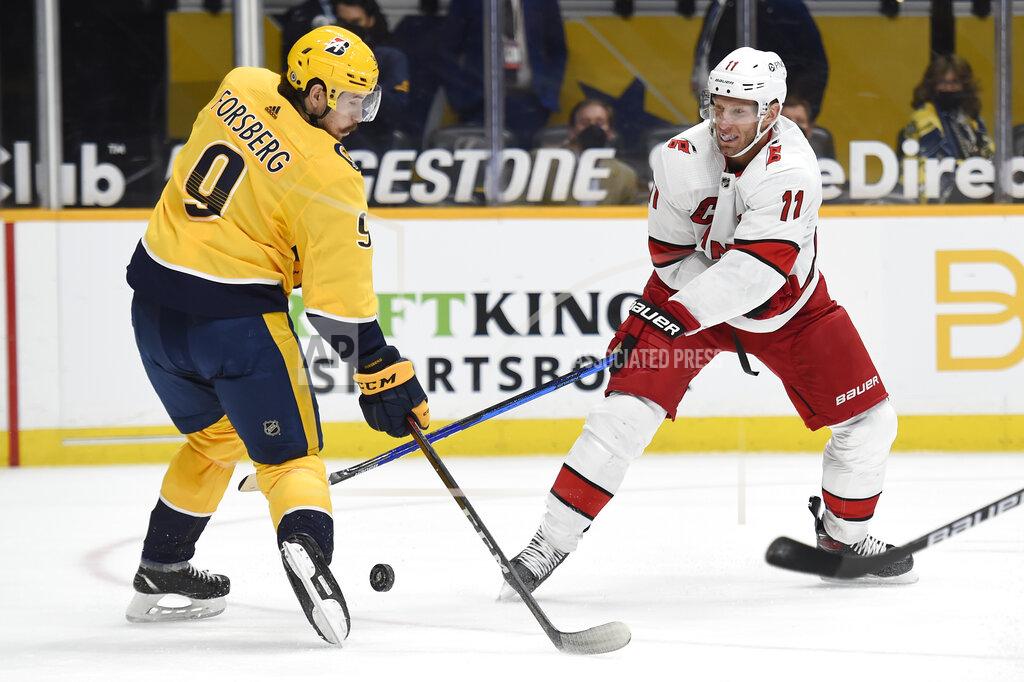 Mark Zaleski Nashville Predators left wing Filip Forsberg (9) blocks a shot by Carolina Hurricanes center Jordan Staal (11) during the first period of an NHL hockey game Saturday, May 8, 2021, in Nashville, Tenn. (AP Photo/Mark Zaleski)